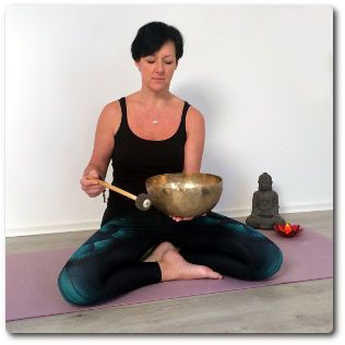 Massageklang Katrin Leutbecher schlägt zur Klang-Meditation die tibetische Klangschale an