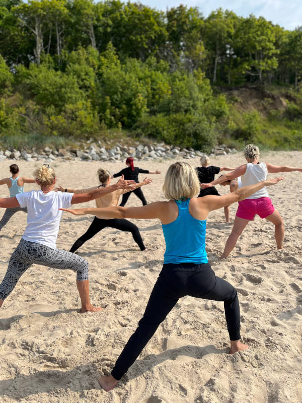 Yogagruppe von Katrin Leutbecher Massageklang am Strand beim Yogaretreat an der polnischen Ostseeküste im Domsolino
